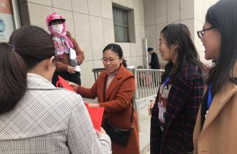 向路人宣傳減少使用塑料垃圾袋，減少白色污染